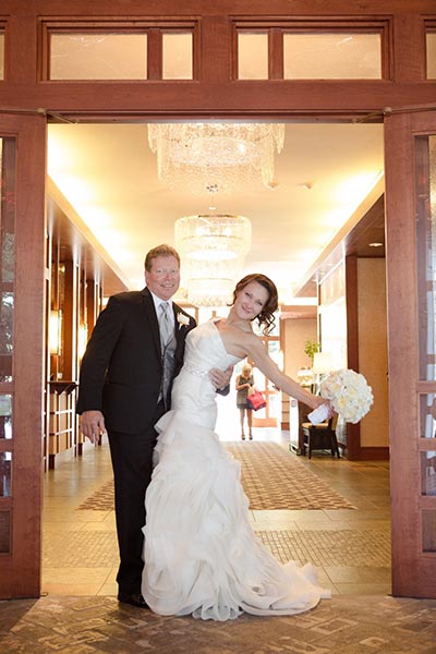 Bride and groom standing in front of hotel