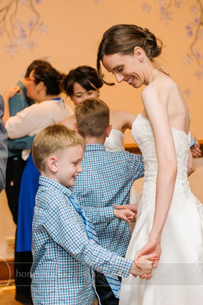bride dancing with boy at wedding reception