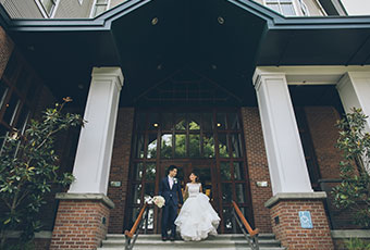 bride and groom stand at the front steps of Kimpton Riverplace Hotel