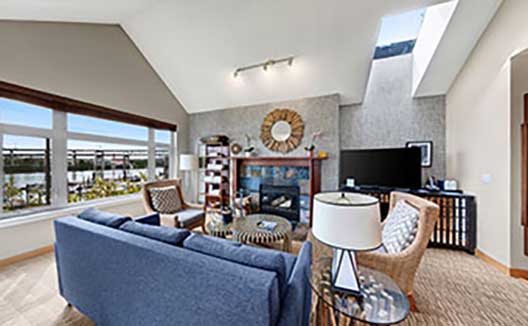 one bedroom cottage living room with a fireplace and couch